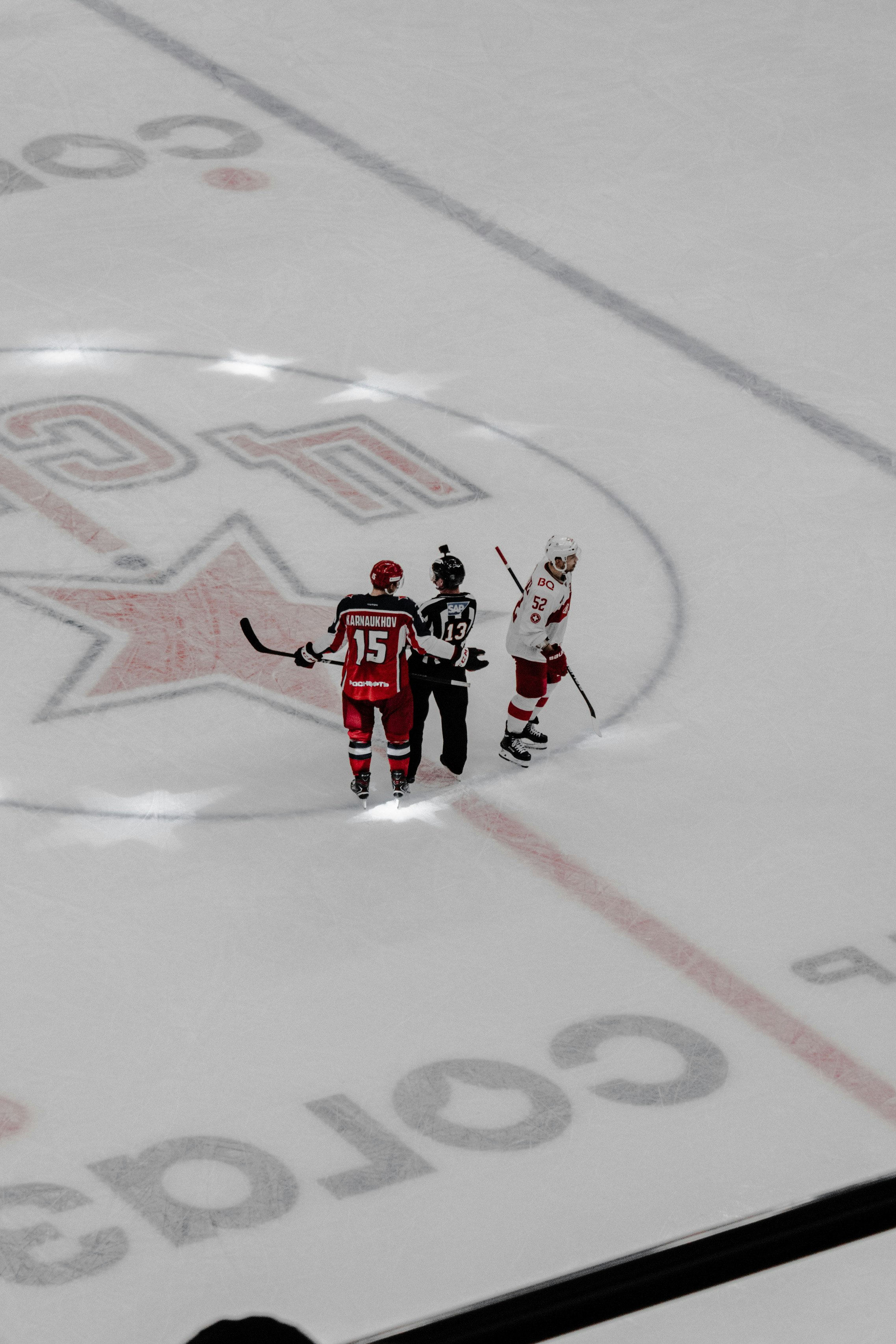 man in red and white jersey shirt riding on white and red hockey board